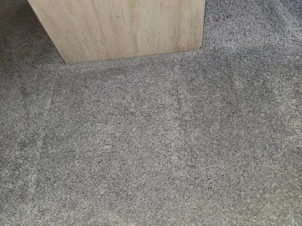 The same spot of gray carpet after cleaning