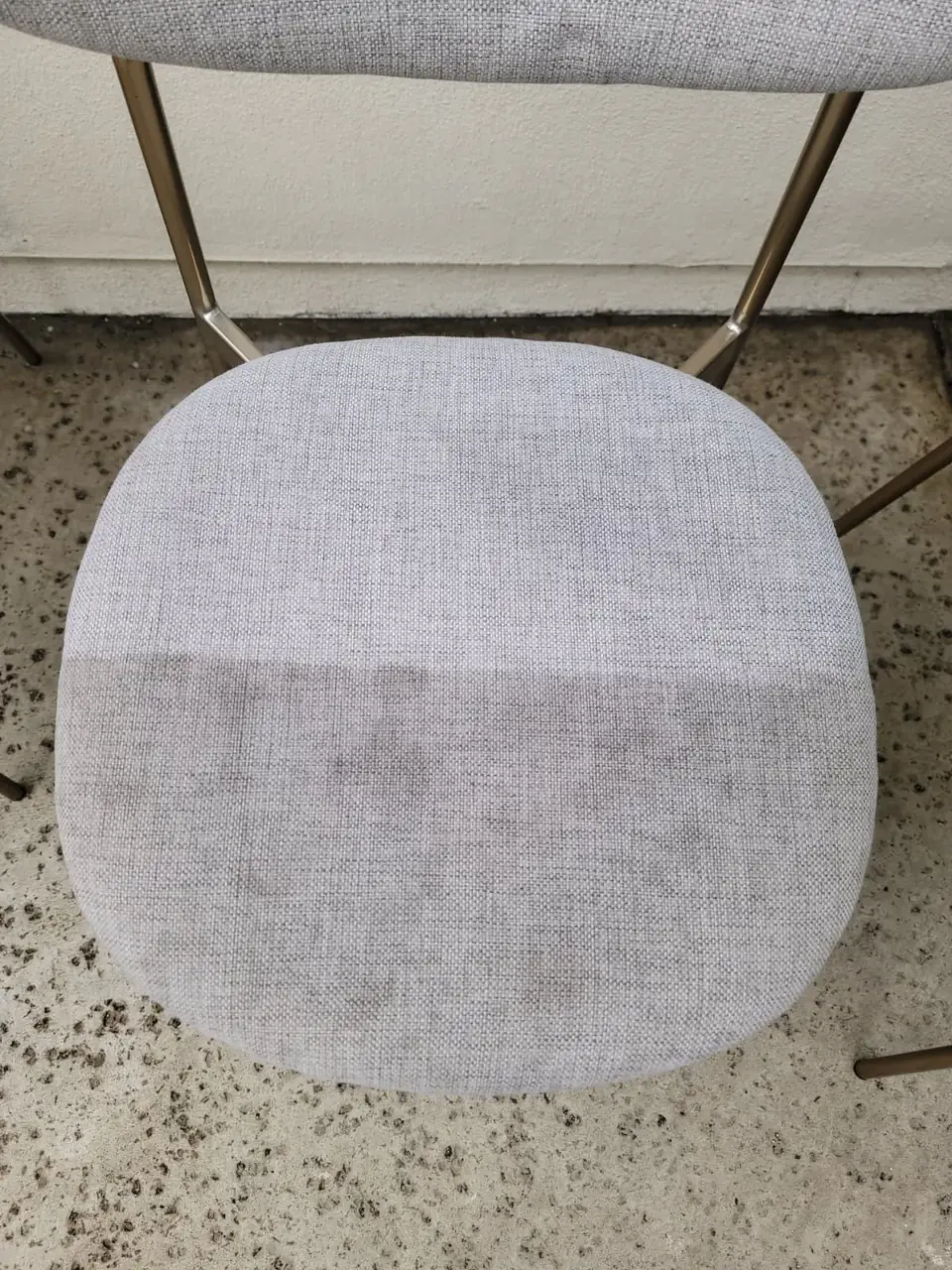 Fabric dining chair seat, part cleaned and part not yet