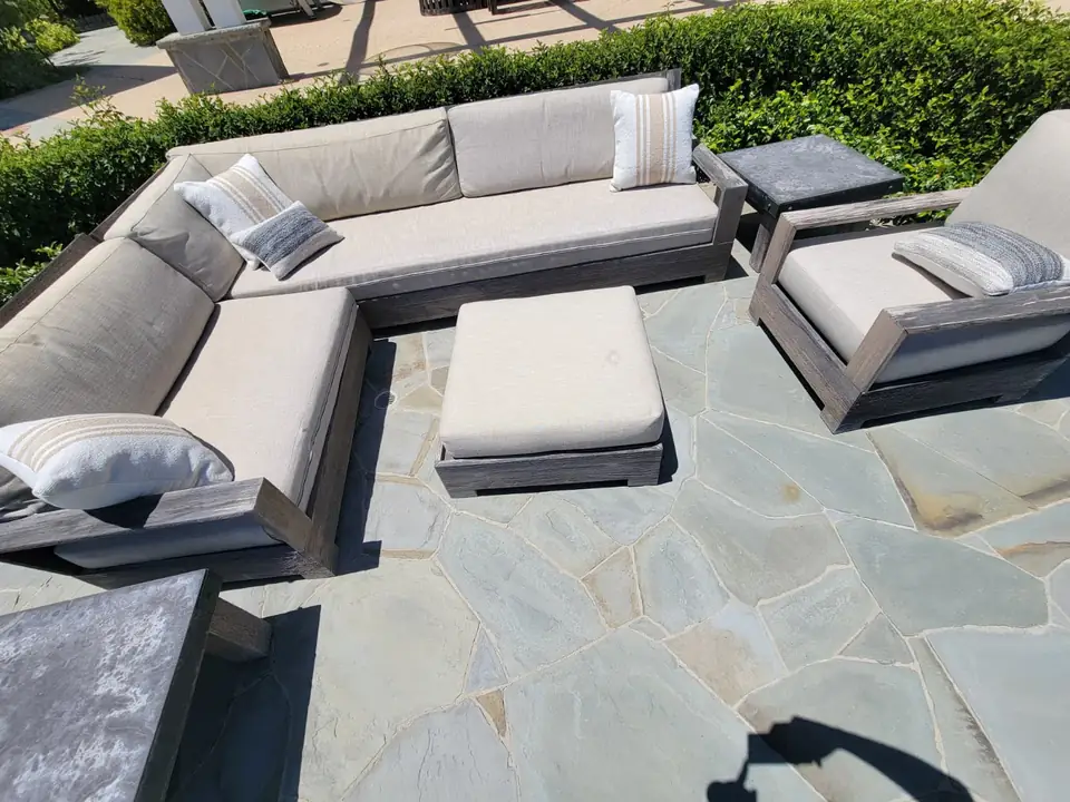 Outdoor patio sectional and chairs with light cushions