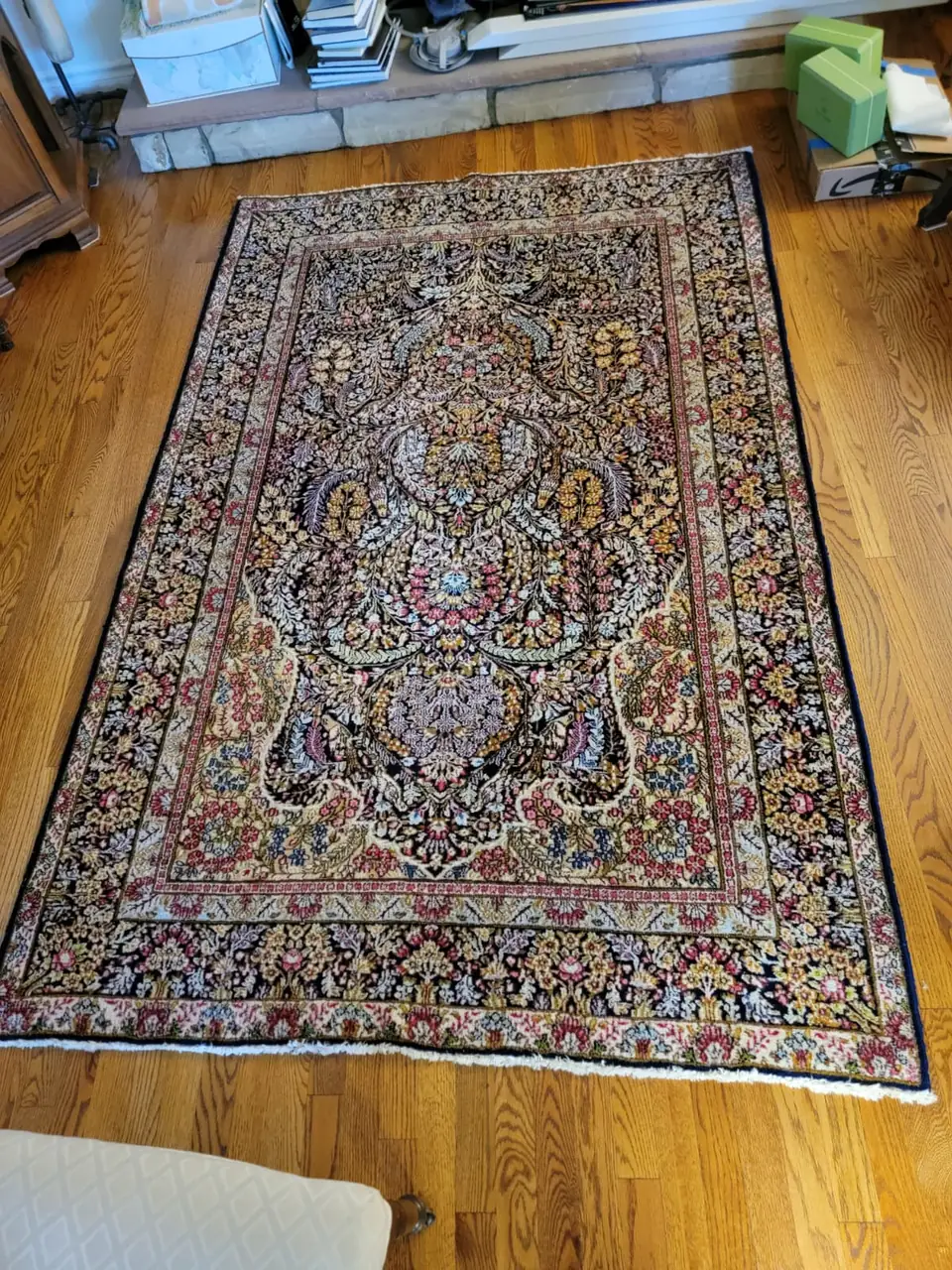 Traditional Persian rug laid flat on a hardwood floor after cleaning